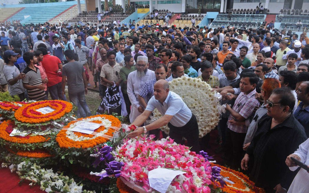 Foreign delegations and ambassadors of various countries stationed in Dhaka place flowers on a memorial as they pay homage to the victims of the hostage-taking.