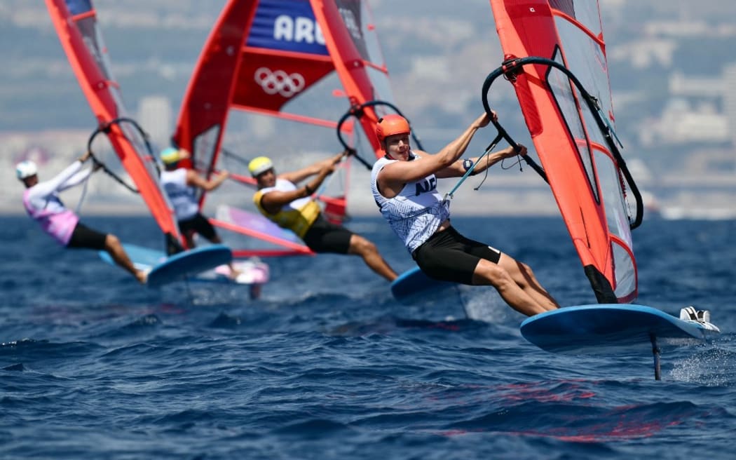 New Zealand's Josh Armit (R) competes in race 12 of the men’s IQFoil windsurfing event during the Paris 2024 Olympic Games sailing competition at the Roucas-Blanc Marina in Marseille on August 1, 2024. (Photo by Christophe SIMON / AFP)