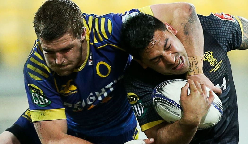 Marvin Karawana of Wellington is tackled by Michael Collins of Otago.