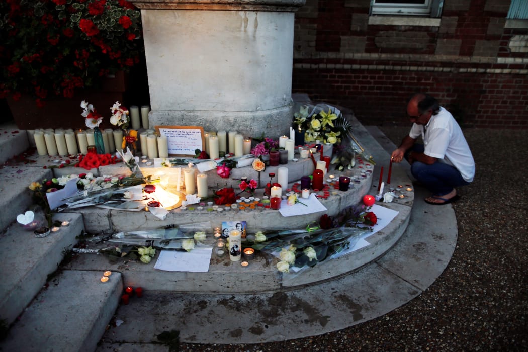 A make-shift memorial in front of the city hall in the Normandy city of Saint-Etienne-du-Rouvray after Father Jacques Hamel was killed in his church.