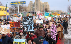 People walk through the streets to protest against ICE after the fatal shooting of Renee Nicole Good in Minneapolis, Minnesota on January 10, 2026. A US Immigration and Customs Enforcement (ICE) agent shot and killed 37-year-old Renee Nicole Good on the streets of Minneapolis on January 7, leading to huge protests and outrage from local leaders who rejected White House claims she was a domestic terrorist. (Photo by CHARLY TRIBALLEAU / AFP)
