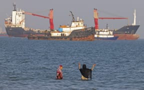 In this picture obtained from Iran's ISNA news agency on June 1, 2026, Iranians swim at Suru Beach in Bandar Abbas along the Strait of Hormuz. The United States and Iran traded strikes as negotiations between the two sides stalled and Tehran again insisted any peace deal must also cover Israel's escalating offensive into Lebanon. (Photo by AMIRHOSSEIN KHORGOOEI / ISNA / AFP) /