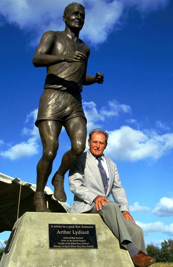 Athletics legend Arthur Lydiard sits atop a statue of him 2001.