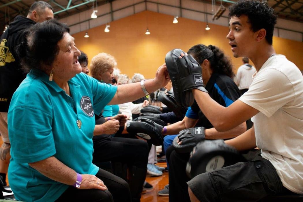 Kaumatua doing line dancing and practicing sparring