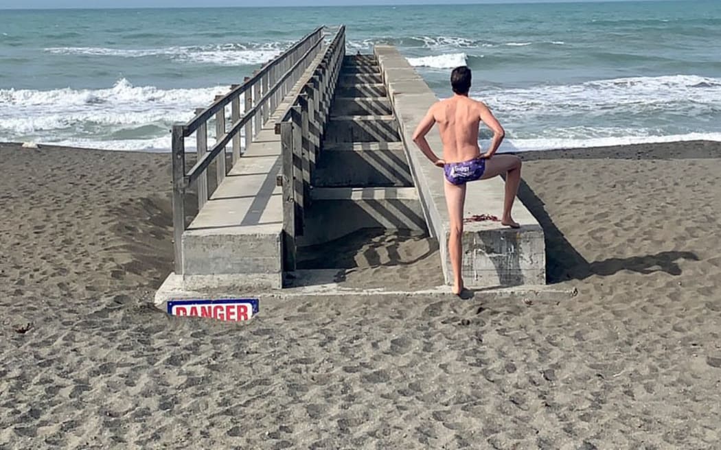 Stuart McEwen poses at the start of another cold plunge at Marfells Beach, Marlborough.