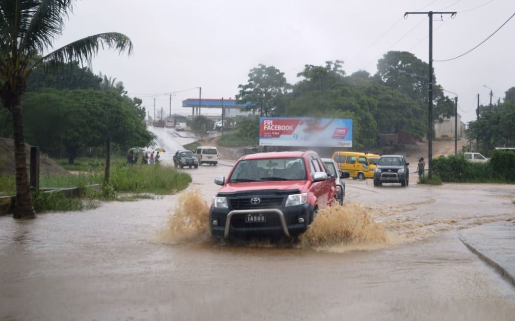 Cars going through floods at Manples, Port Vila
