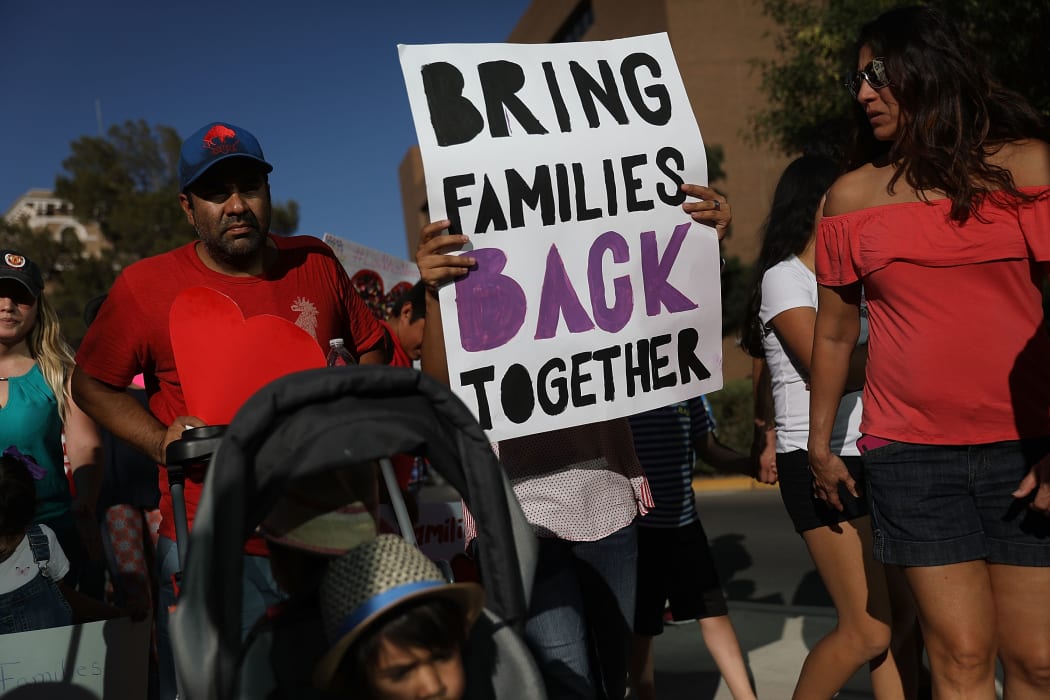 Protesters walk though the streets as they protest against the Trump administration's policy of separating children from their parents on June 21, 2018 in El Paso, Texas.