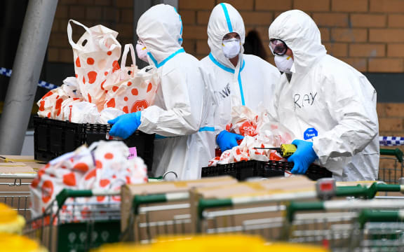 Members of the Melbourne Fire Brigade (MFB) prepare to take food parcels to residents in a locked down public housing estate in Melbourne earlier in July.