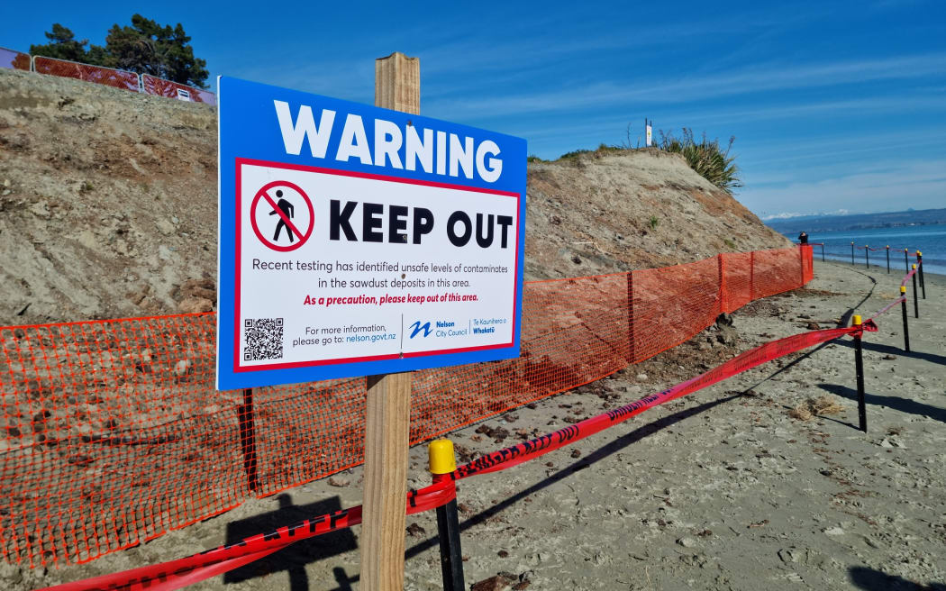 A sign warning of contaminated sawdust, which has been found to contain high levels of heavy metals.