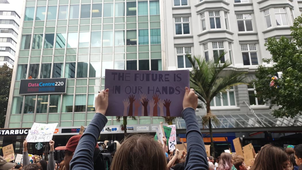 A sign reading 'the future is in our hands' at the Auckland march.