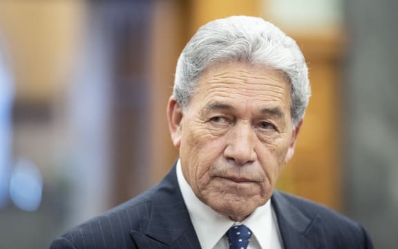Winston Peters speaks to media on his way to the debating chamber in Parliament, Wellington.