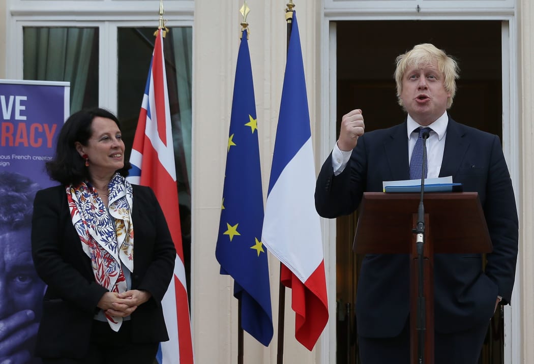 French Ambassador to Britain, Sylvie Bermann (L) listens as British Foreign Secretary Boris Johnson speaks as he attends during a reception at the French Ambassador's residence in west London on July 14, 2016.