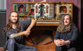 Jackson Harvey and Alex Tower with a retrofuturistic LEGO piano they crafted for RELICS.