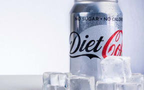 Can of Diet Coke and ice cubes. Diet Coke is sweetened with aspartame instead of sugar.