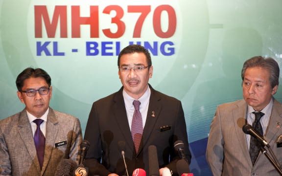 Malaysia's acting Transport Minister Hishammuddin Hussein, centre and Foreign Minister Anifah Aman, right.