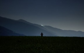 person alone in mountains at night