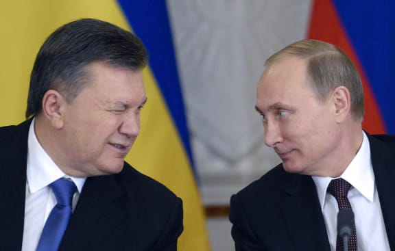 President Viktor Yanukovych winks at President Vladimir Putin during the announcement at the Kremlin.