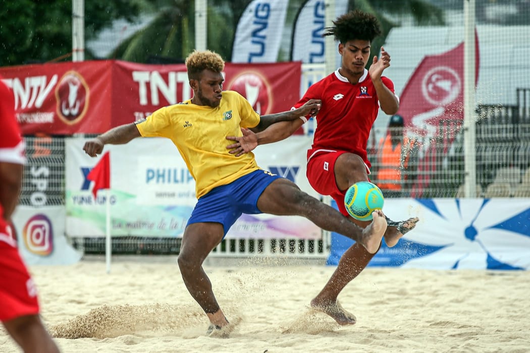 Tonga's Penisimani Veikoso goes up against Solomon Islands Anthony Talo. OFC Beach Soccer Nations Cup 2019, Aorai Tini Hau, Tahiti, Wednesday 19th June 2019.