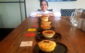 One of the 2023 Vegan Pie Awards judges, Jasbir Kaur, with some of the pies in the competition.