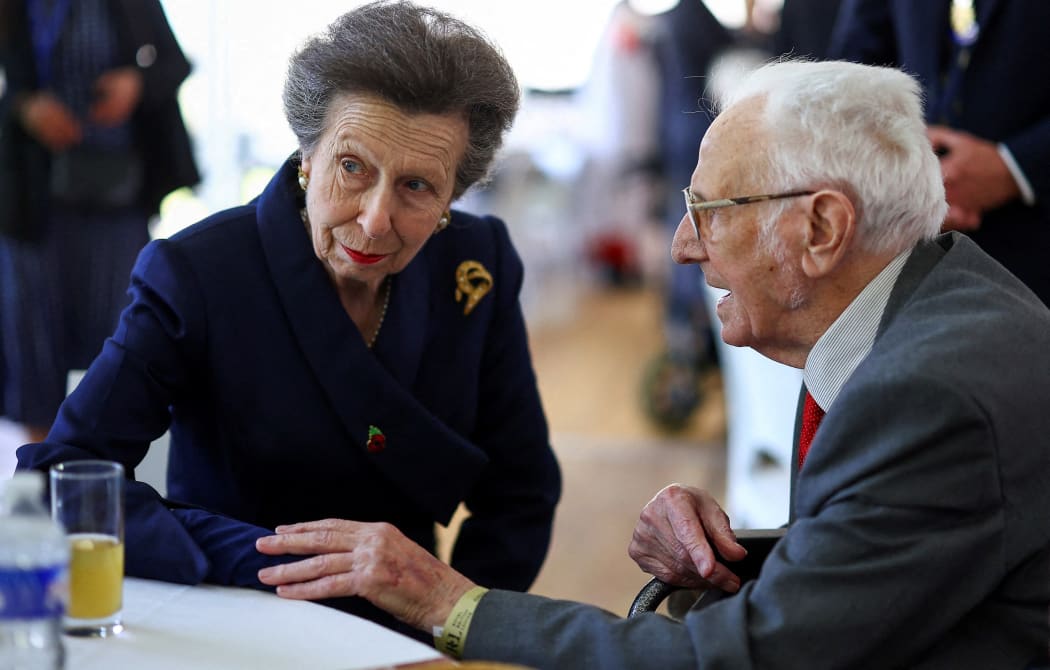 Britain's Princess Anne, Princess Royal (L) speaks with a veteran prior to attend a service of commemoration at Bayeux Cemetery, in Bayeux, Normandy, northwestern France, as part of the events to mark the 80th anniversary commemorations of Allied amphibious landing (D-Day Landings) in France in 1944, on June 5, 2024. Heads of state and veterans are due to mark the anniversary of D-Day on June 6, a date that was key to Allied Europe's eventual victory against the Nazis in World War II. (Photo by Hannah McKay / POOL / AFP)