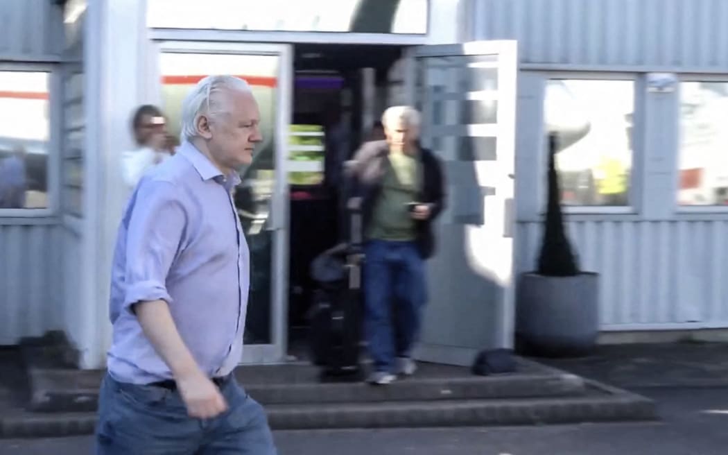 This screen shot courtesy of WikiLeaks X page shows Wikileaks founder Julian Assange walking to board a plane from London Stansted Airport on June 24, 2024. The 52-year-old Australian was taken Monday, June 24, from Belmarsh prison to London's Stansted airport, a Wikileaks statement said, from where he boarded a flight to an unnamed destination.