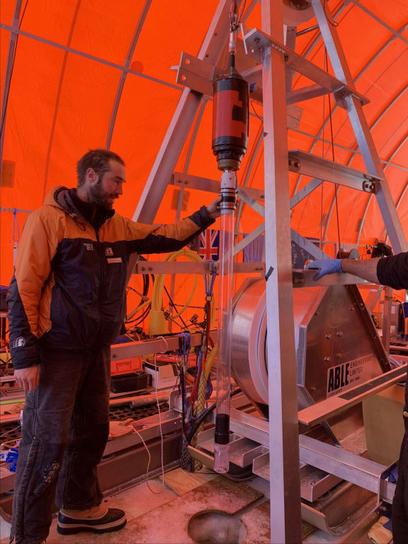 Martin Forbes, from the University of Otago, dropping a gravity corer through a hole made by using hot water to drill through 600 metres of ice.