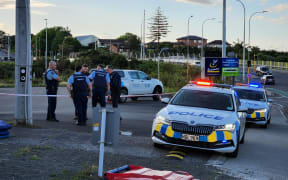 Police at a walkway beside a Massey, West Auckland, badminton centre after what they are calling a sudden death.