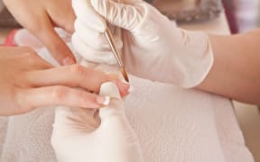 A beauty consultant working on a customer's acrylic fingernails (file picture).