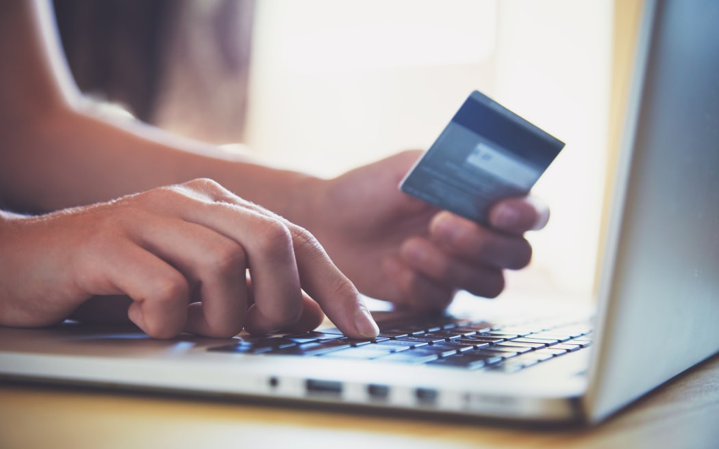 Hands holding credit card and using laptop. Online shopping