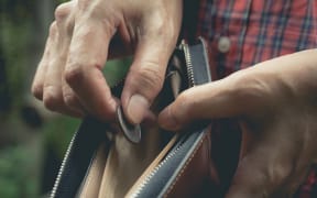 Close-up woman standing and holding money coin with wallet empty of money