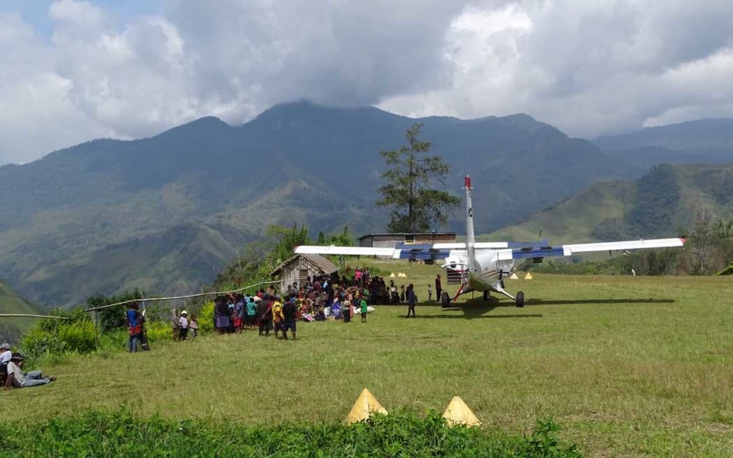 Mission Aviation fellowship aircraft at a rural airstrip in Ande, Papua New Guinea.