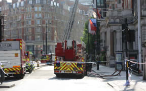 A police officer takes security measures after a blaze broke out at a hotel building near central Hyde Park in London, United Kingdom on June 06, 2018.