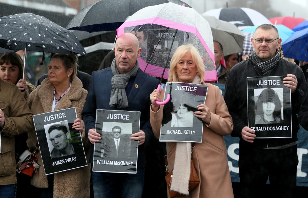 Relatives and supporters of the victims of the 1972 Bloody Sunday killings hold images of those who died.