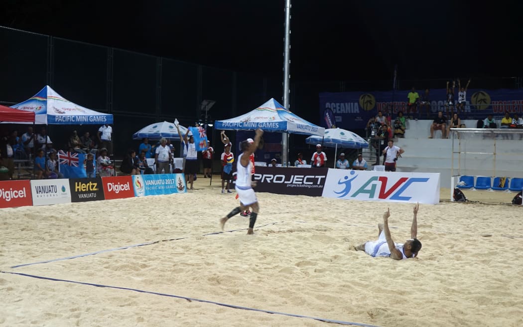 Fiji men's beach volleyball team celebrating after beating PNG