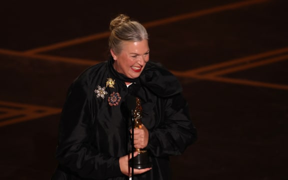 US costume designer Kate Hawley holds her Oscar for Best Costume Design for "Frankenstein" onstage during the 98th Annual Academy Awards at the Dolby Theatre in Hollywood, California on March 15, 2026.