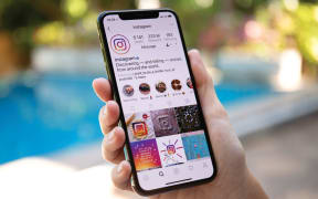 Koh Samui, Thailand - March 21, 2018: Woman hand holding iPhone X with social networking service Instagram on the screen.