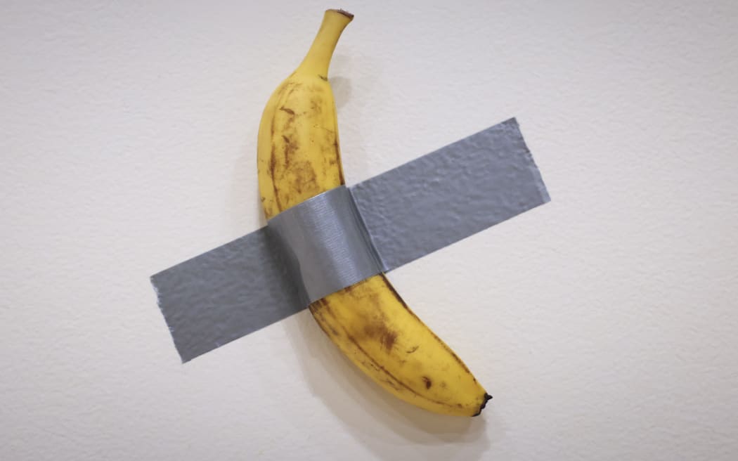 Italian visual artist Maurizio Cattelan's duct-taped Banana entitled "Comedian," is on display during a media preview at Sotheby's in New York, on November 8, 2024.