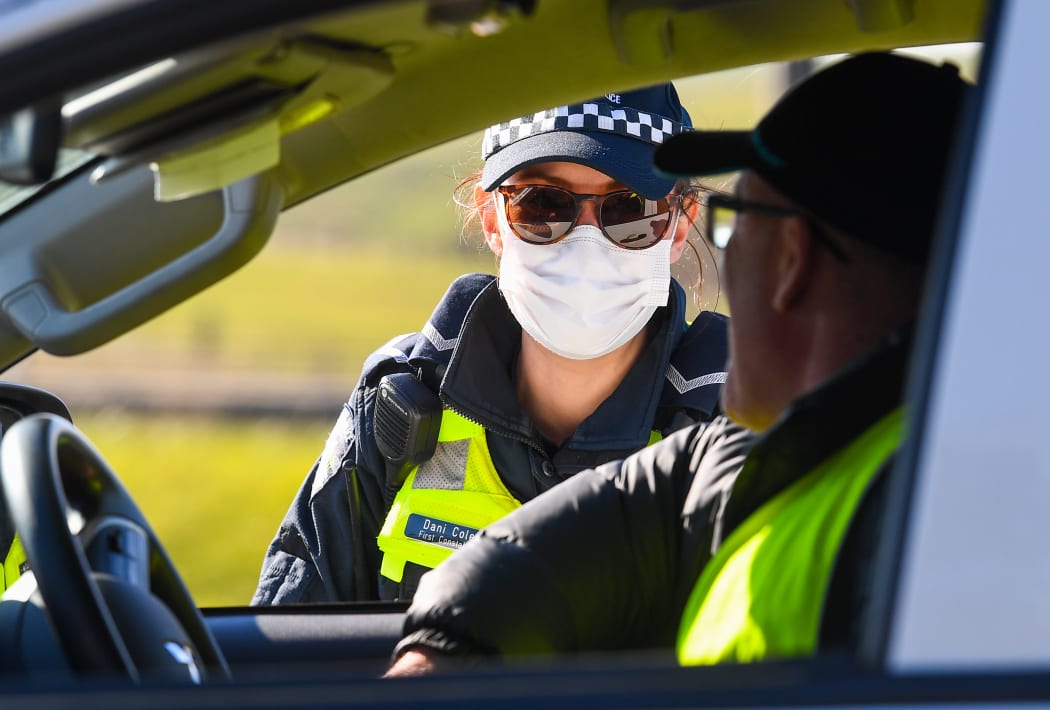 Police conduct roadside checks on the outskirts of Melbourne on July  9, 2020 on the first day of the city's new lockdown after an outbreak of the Covid-19 coronavirus.