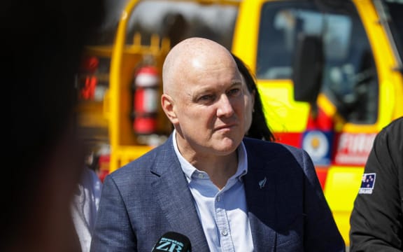 Prime Minister Christopher Luxon speaks with reporters on 22 February, 2024, after meeting with locals and emergency services who responded to a major fire at Port Hills, Canterbury.