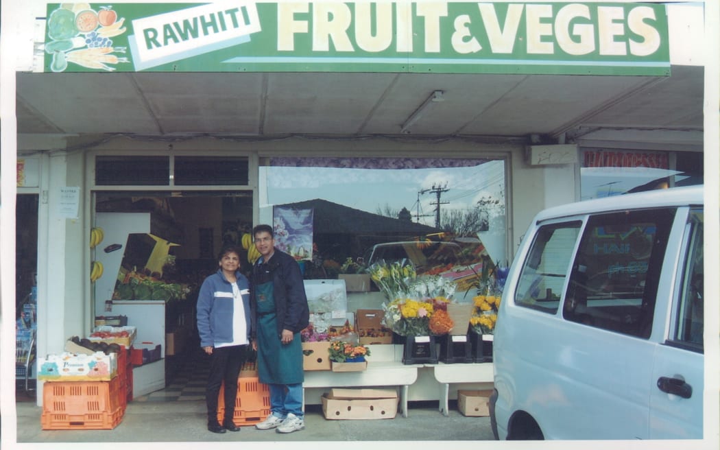 Patel's parents, Indira and Magan, standing outside their Onehunga fruit shop in the early 2000s.