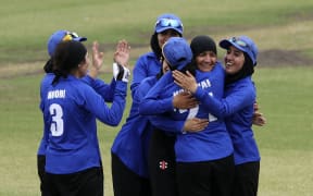 An Afghanistan Women's XI celebrate a wicket against a Cricket Without Borders XI in Melbourne.
