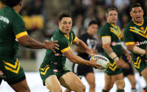 Cooper Cronk passes with Corey Parker watching on.