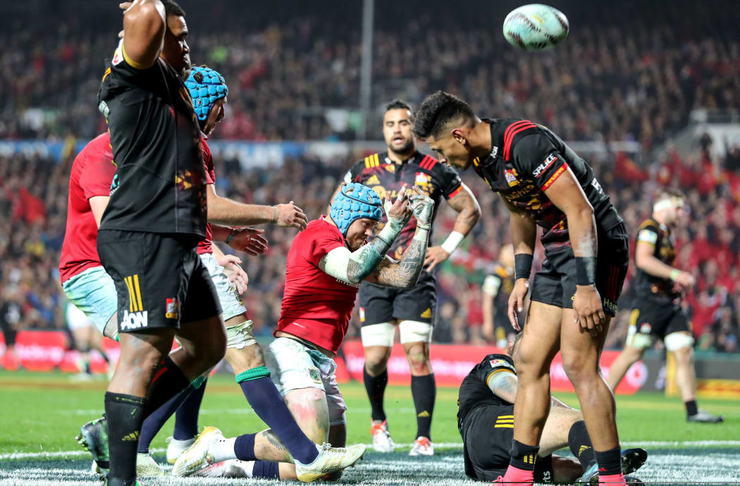 Lions player Jack Nowell celebrates scoring their third try as Chiefs players gather themselves.