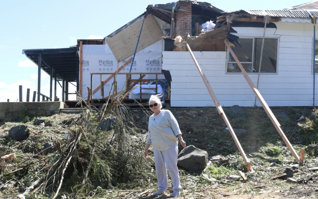 Robyn Hale and the remnants of her Kaitangata home, after severe spring storms, in October, 2025.
