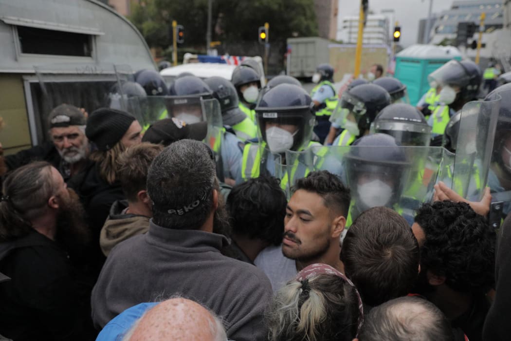 Police undertake an early morning operation to restore order and access to the area around Parliament.