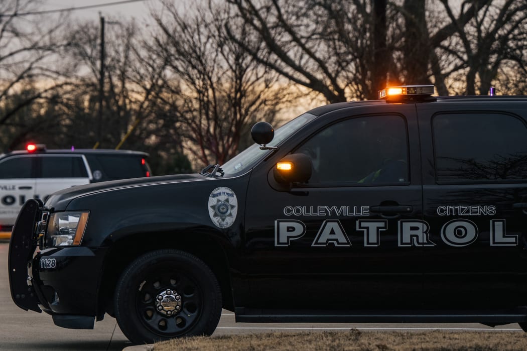 Colleyville law enforcement sit parked near the Congregation Beth Israel synagogue in Colleyville, Texas.