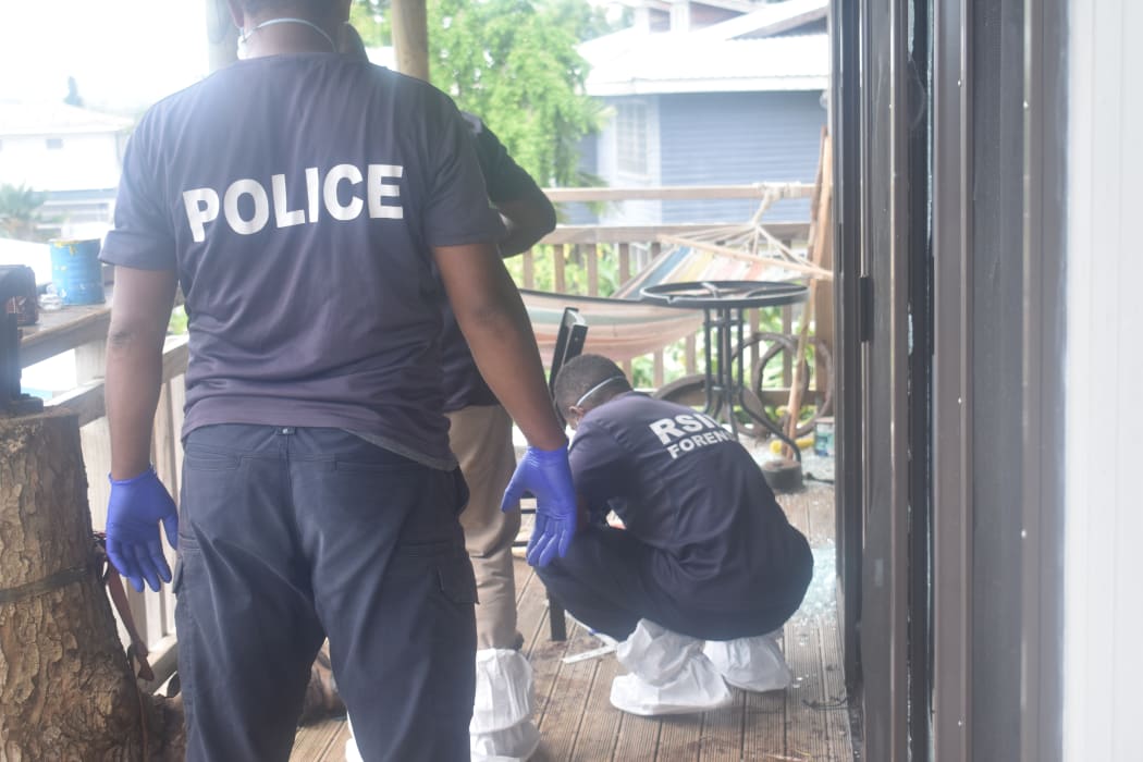 Forensic officers examine site of Sunday's explosion