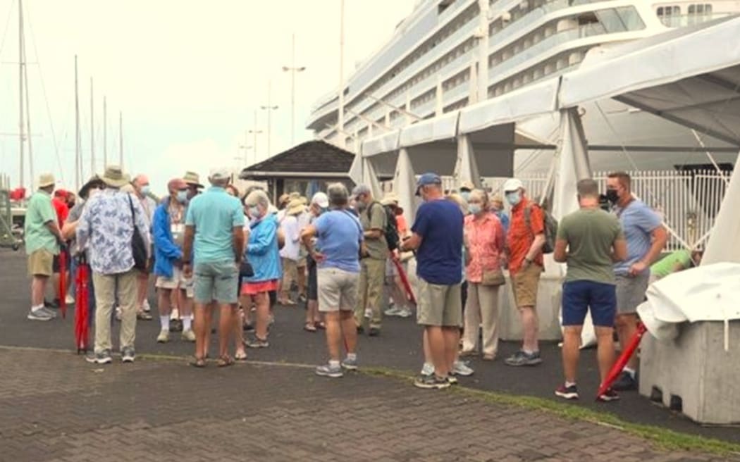 Foreign tourists arrive in Tahiti on a cruise liner.