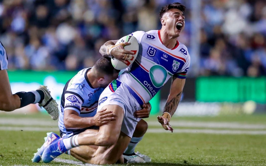 Charnze Nicoll-Klokstad is brought down by a Sharks defender.