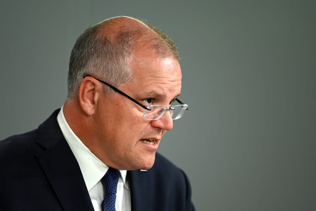 Australia's Prime Minister Scott Morrison briefs media about the flooding situation in Queensland. (Photo by Saeed KHAN / AFP)
